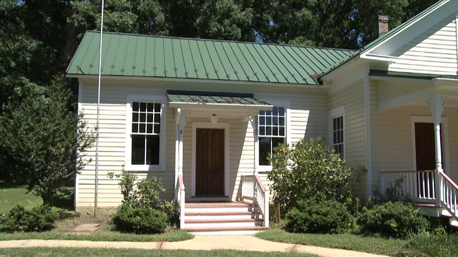 Color photograph of the Forestville School taken in 2014, showing a close-up view of the 1912 addition to the schoolhouse. The additional room is smaller than the original school building in size. The addition originally had three windows on the side, but the center window has since been removed and was replaced by a doorway.