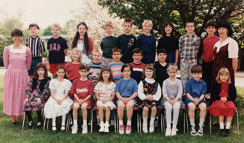 First grade class photograph taken during the 1994 to 1995 school year. 23 children and two teachers are pictured. This is a Japanese Partial Immersion first grade class and one teacher is the English teacher and the other is the Japanese teacher.