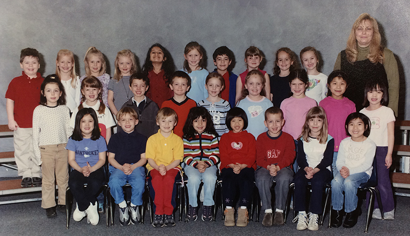 Afternoon kindergarten class photograph taken during the 2002 to 2003 school year. 28 children and one teacher are pictured. The children are arranged in three rows on risers in front of a plain grey background.