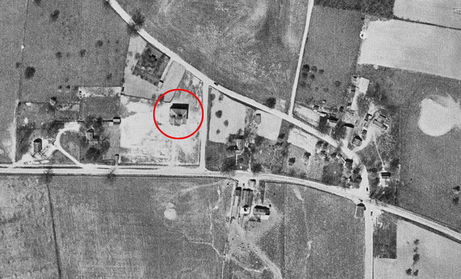 Black and white aerial photograph of the village of Forestville taken in 1937. The village is seen from directly overhead. The intersection of Georgetown Pike and Walker Road is on the right. Several homes and businesses are visible, but much of the surrounding area is farm fields. The Forestville School, in the center of the image, has been circled in red.