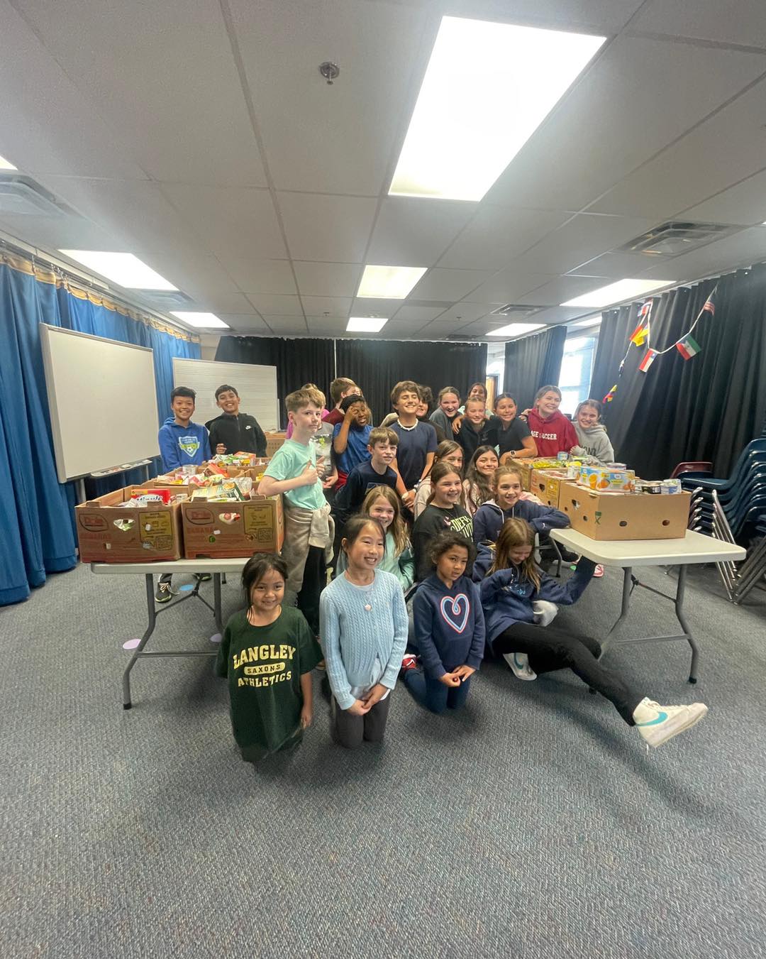 Students pose with donated food boxed up and ready to distribute