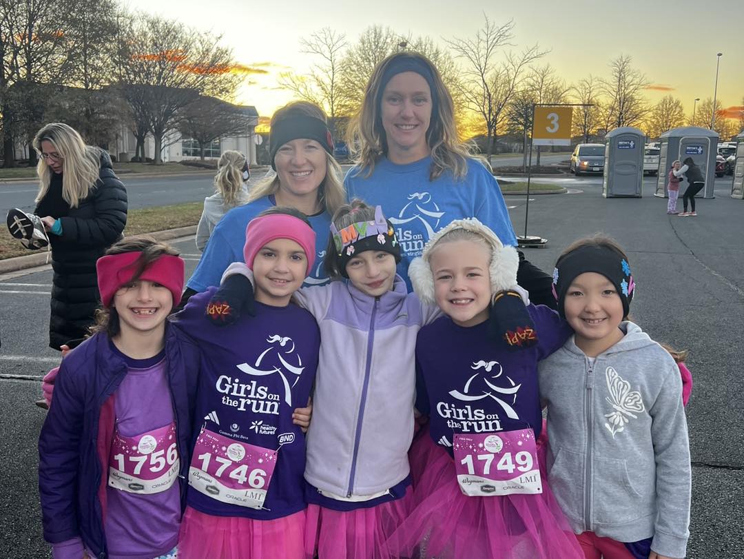 Girls pose with sponsors after racing